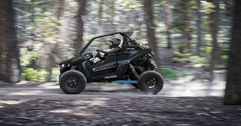 Polaris RZR RS1 driving fast in the forrest