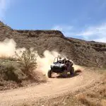 UTV driving fast on dirt road