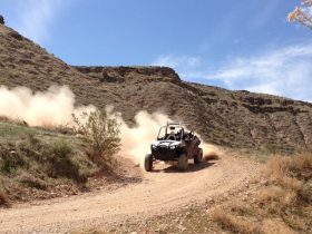 UTV driving fast on dirt road