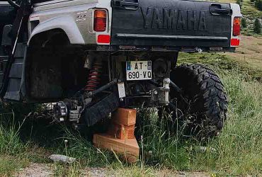 UTV jacked up on wooden blocks while changing tire