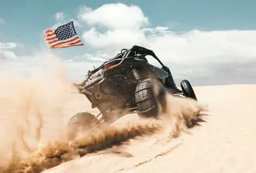 UTV with paddle sand tires and USA flag
