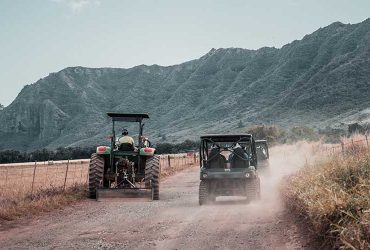 UTVs and tractor on road