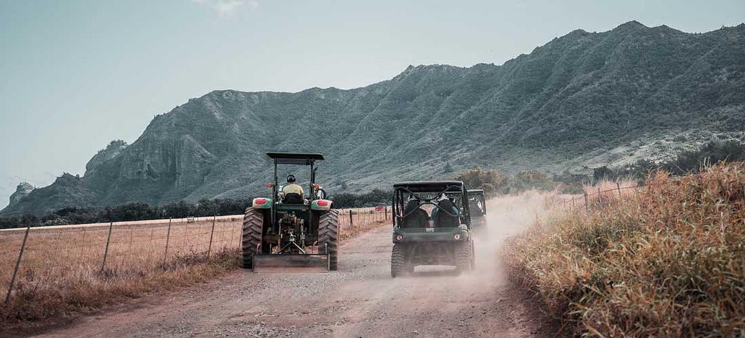 UTVs and tractor on road