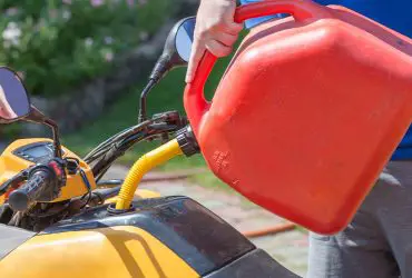 Man refueling ATV with gasoline