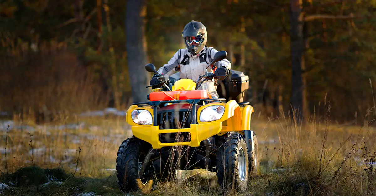 Man driving ATV with power steering offroad